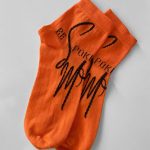 Orange short sports socks with black branding